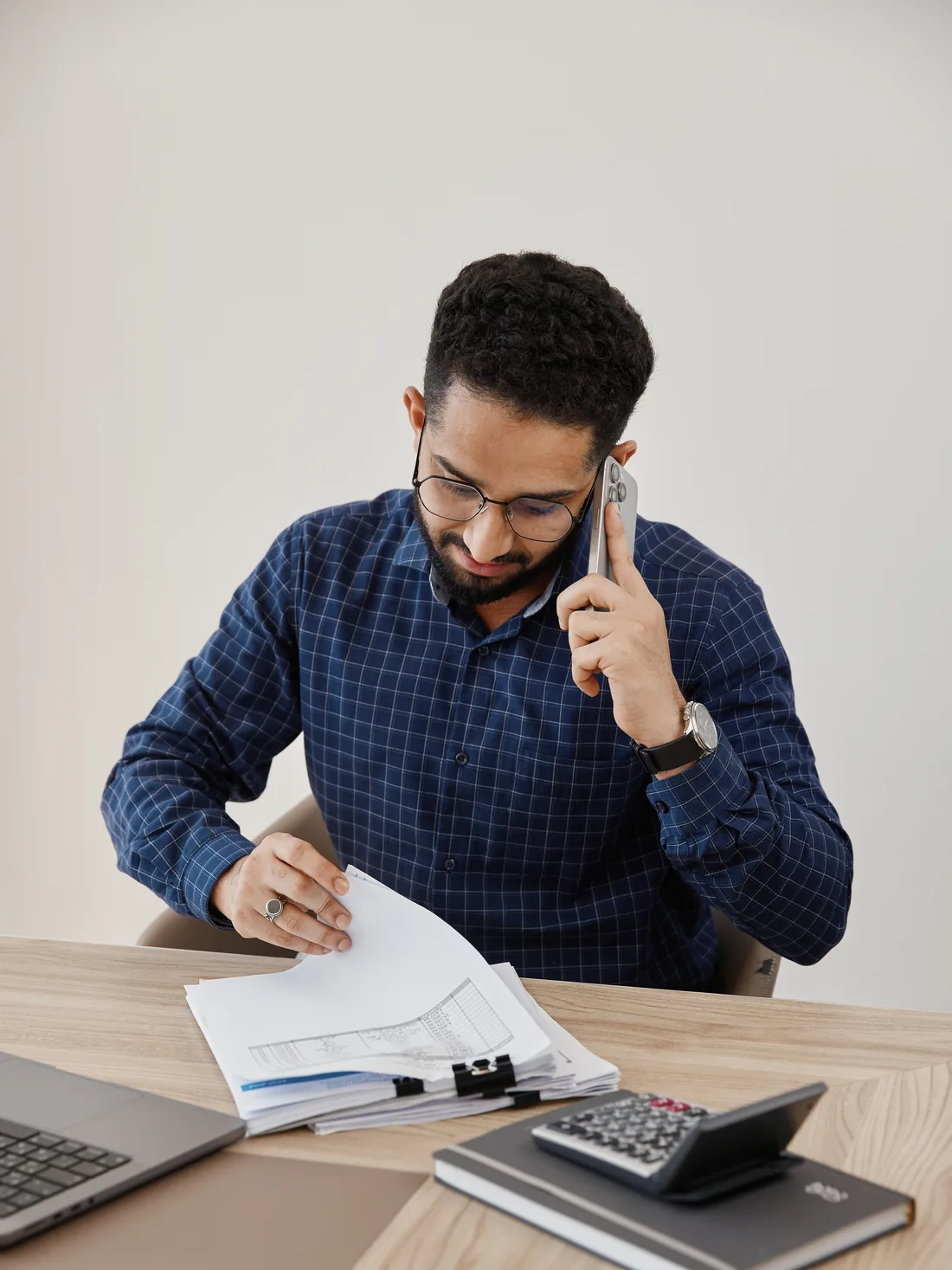 A Peak Finance accountant on a call with a client, books open